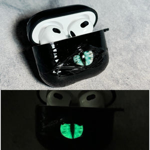 A white 3D textured AirPods case featuring a realistic glowing blue eye design with a star charm.