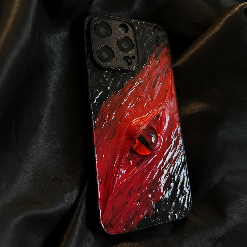 A black and red 3D textured iPhone case featuring a realistic volcanic eye design.