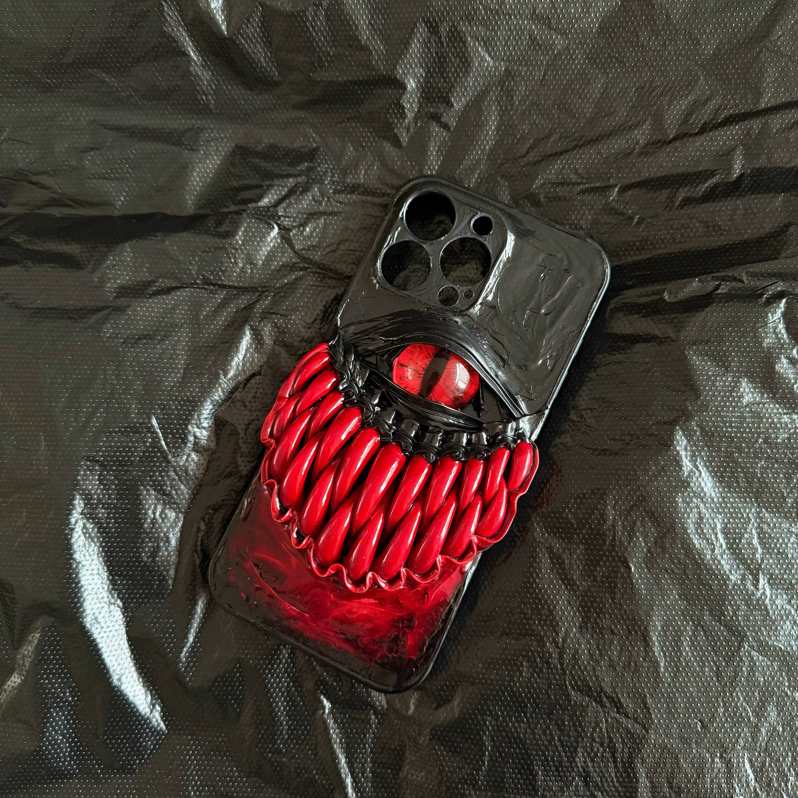 Handmade 3D gothic monster eye and teeth design on a black iPhone case