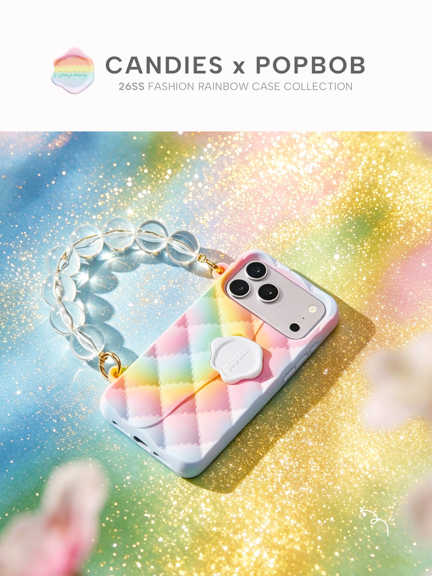 Candies x Popbob quilted rainbow iPhone case with a clear beaded wrist strap under sunlight.