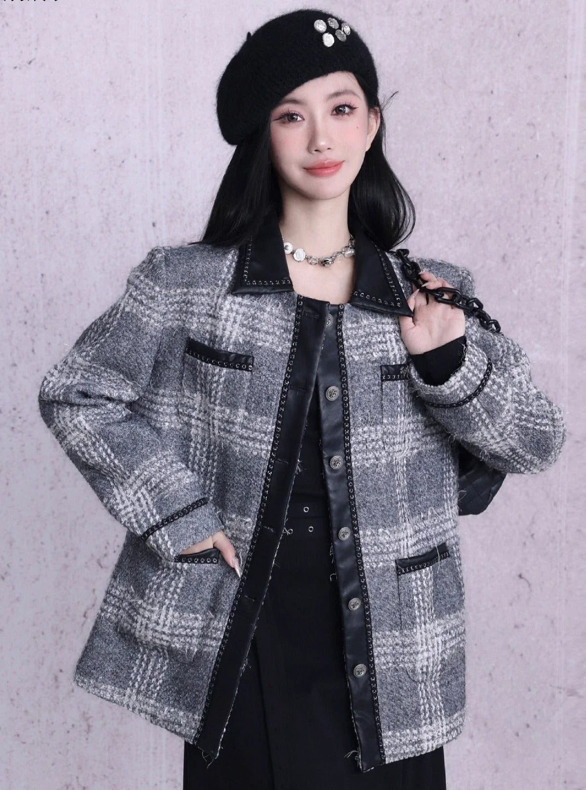 A woman wearing a black or gray beret with button embellishments.
