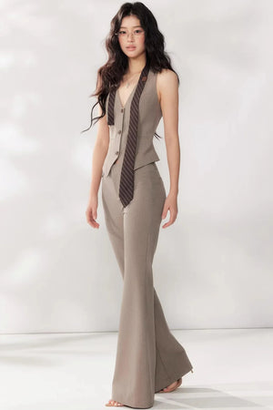 A light beige halter-neck blazer vest and trouser set.