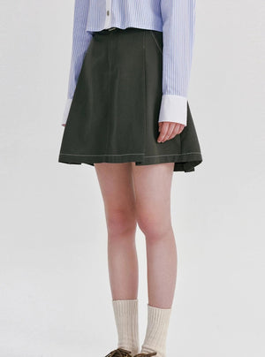 A high-waisted gray mini skirt with contrast stitching.