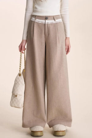 Oatmeal latte wide-leg wool pants with lace patchwork detail at the waist.