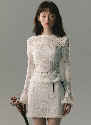 A woman wearing a white lace two-piece set.