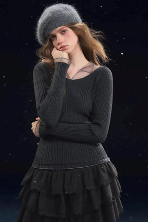 A long-sleeve ribbed top with mesh neckline detail.