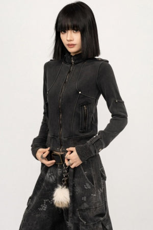A woman wearing a black retro-style zipper cardigan with a mock neck.
