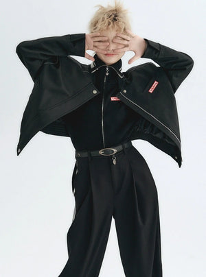 A person wearing a stylish leather jacket with a logo patch.