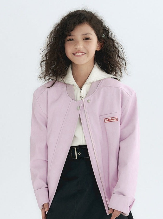 A person wearing a stylish leather jacket with a logo patch.