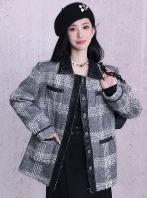 A woman wearing a black or gray beret with button embellishments.