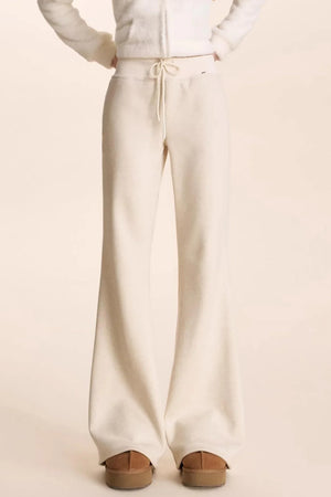 Oatmeal-colored cashmere blend flared sweatpants with a drawstring waist.