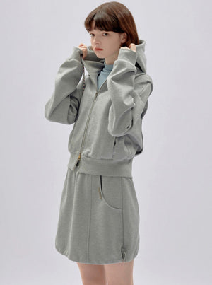 A gray cropped zip-up hoodie.