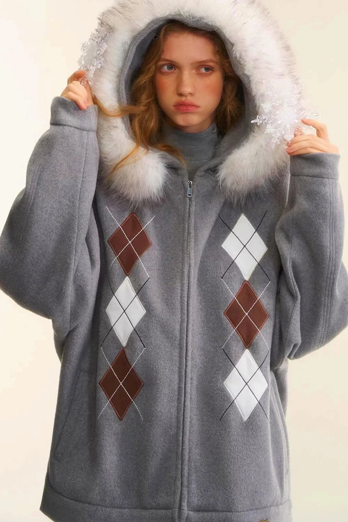 A gray wool jacket with diamond embroidery and a faux fur hood.