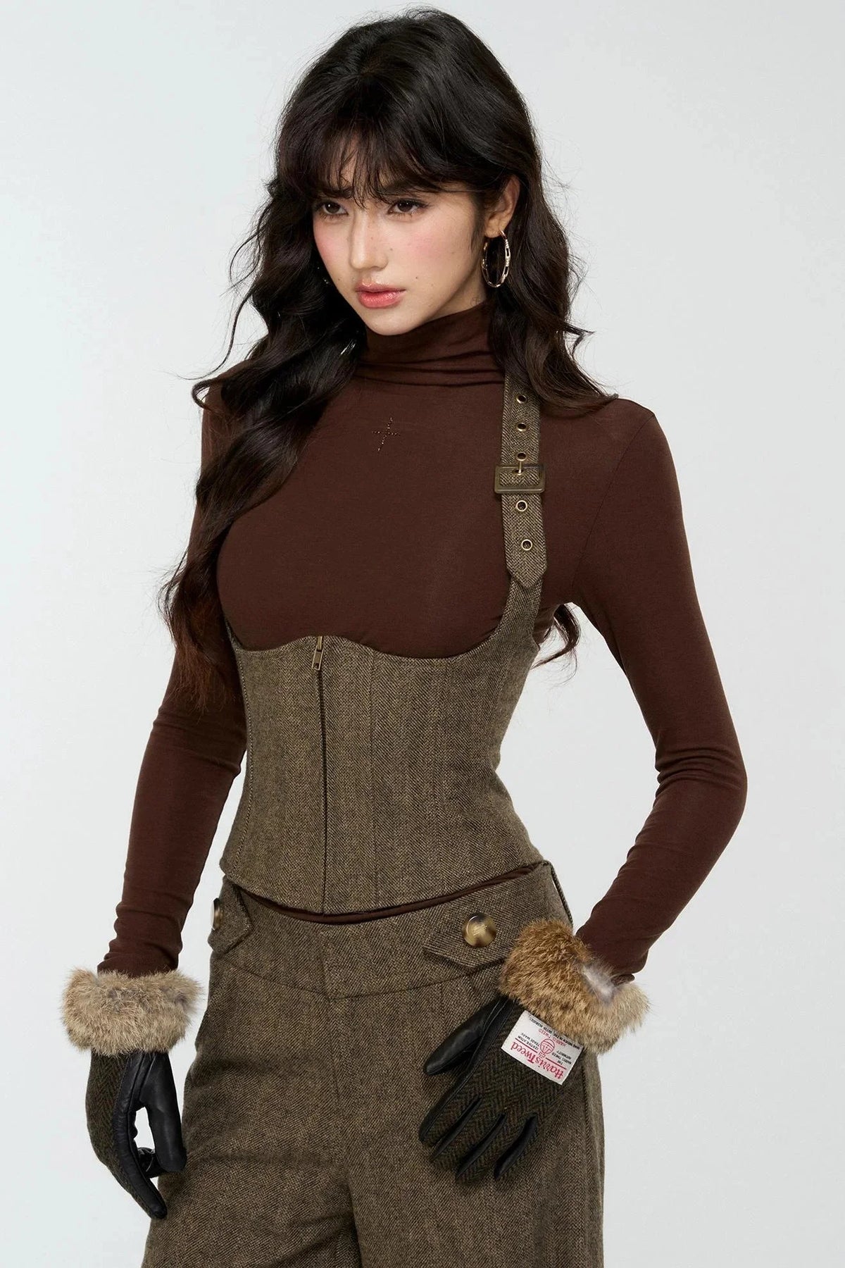 A model wearing an elegant woolen tweed vest and matching pants set.