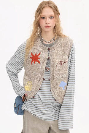 Beige knitted vest with colorful embroidery and beads.
