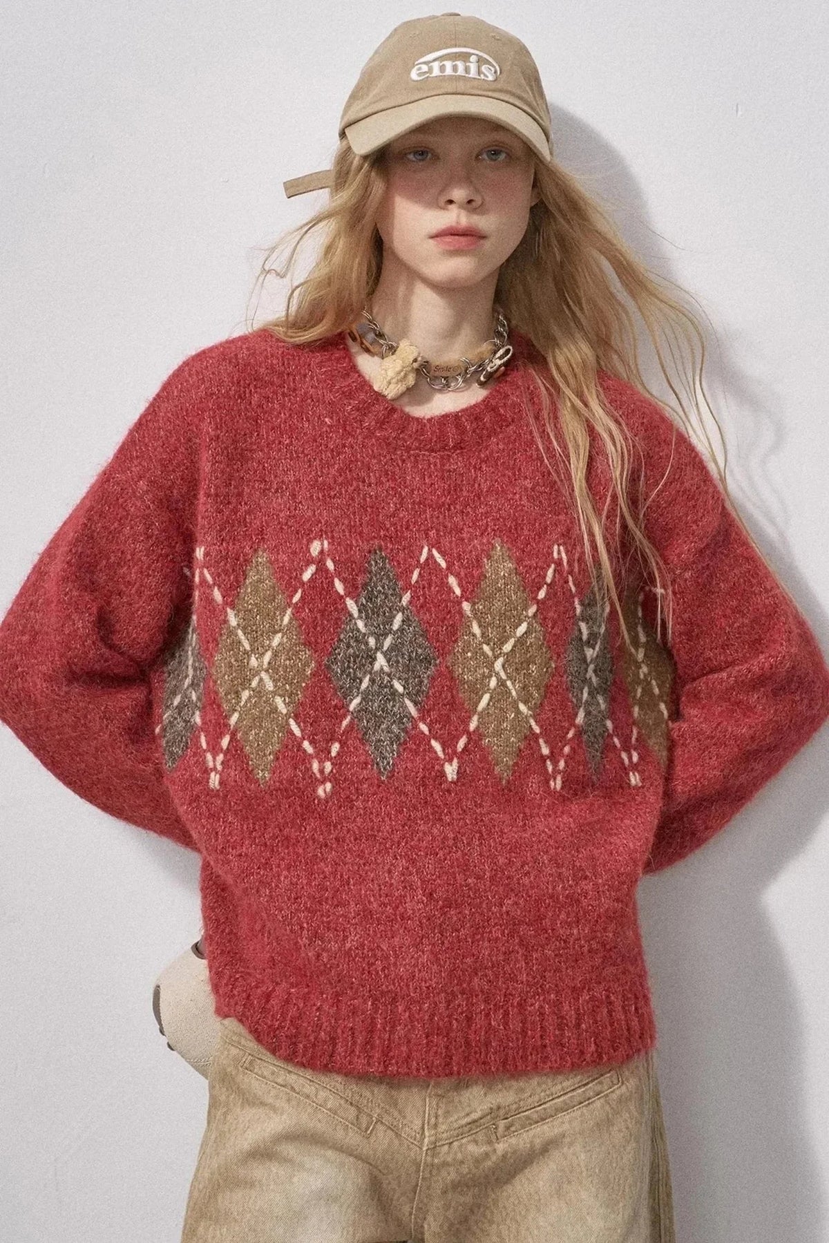 A red and brown diamond-patterned knit sweater.