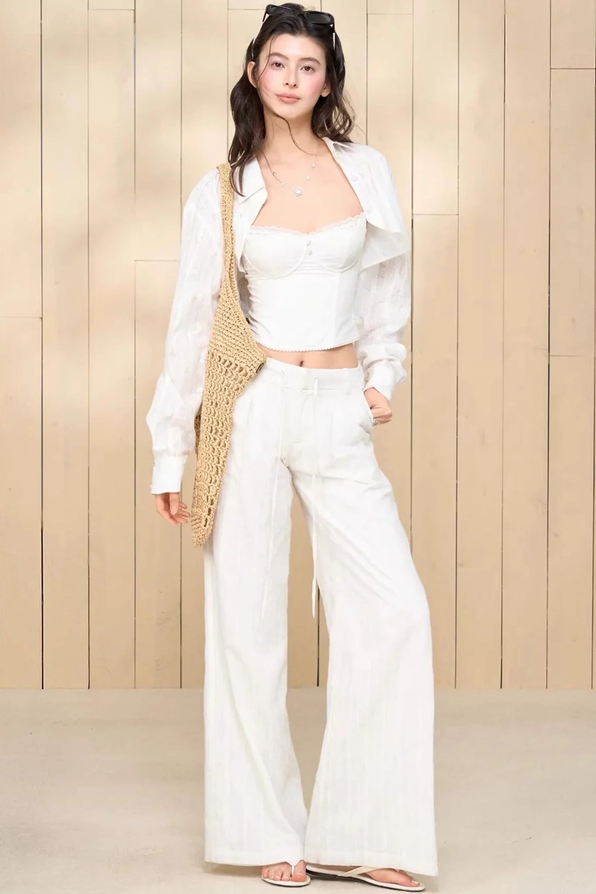 A white lace camisole and matching pants set for women.
