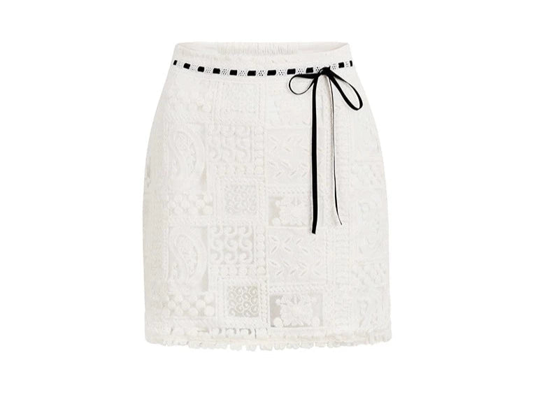 A woman wearing a white lace two-piece set.