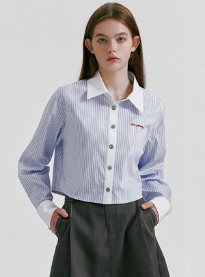 A woman wearing a long-sleeve striped button-down shirt with a crisp collar.