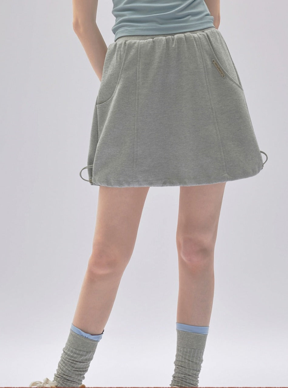 A gray mini skirt with a drawstring waist.