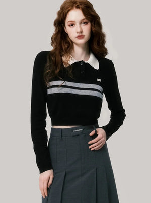 A woman wearing a black and gray contrast polo shirt.