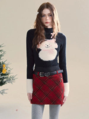 A woman wearing a black long-sleeved top with a cute graphic design.