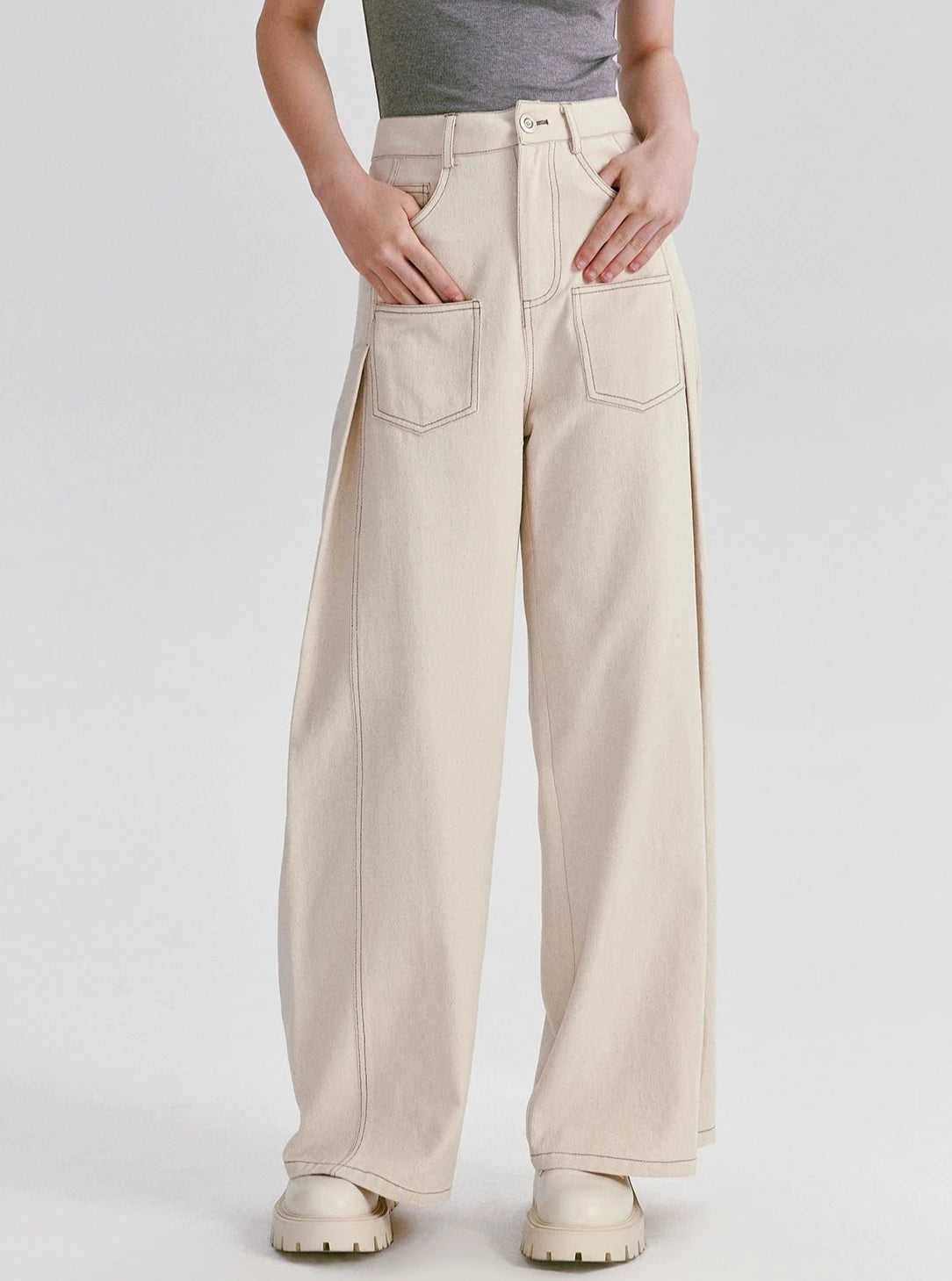 A pair of high-waisted wide-leg cotton pants in white.
