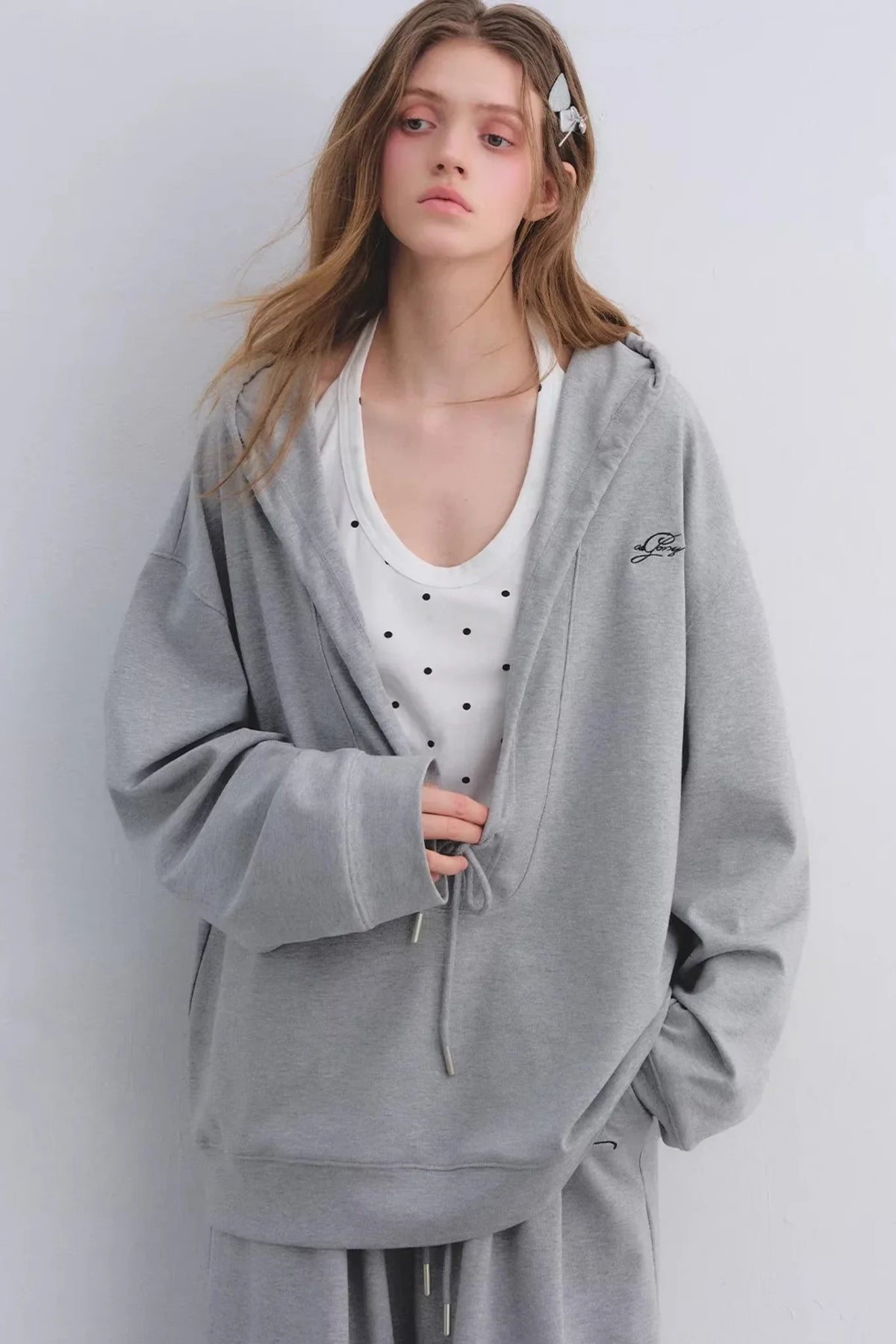 A comfortable gray hooded sweatshirt and matching pants set.
