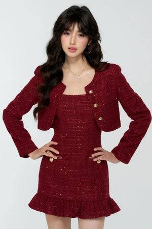 A woman wearing a red tweed-style jacket and matching dress set.