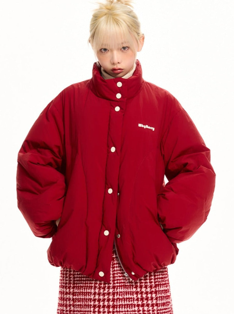 A model wearing a bright red puffer jacket.