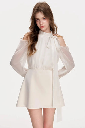 A white satin off-shoulder A-line dress with long sleeves.