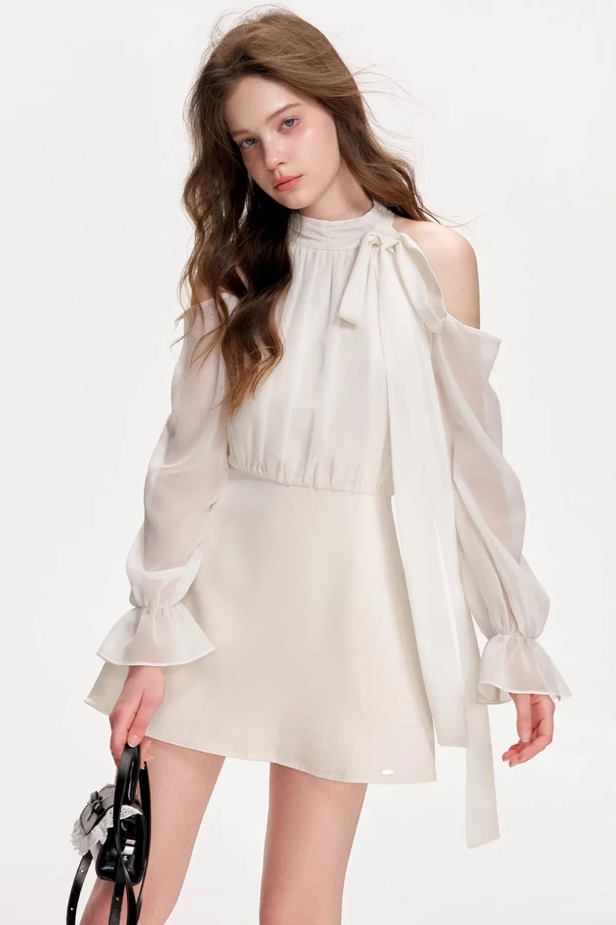 A white satin off-shoulder A-line dress with long sleeves.