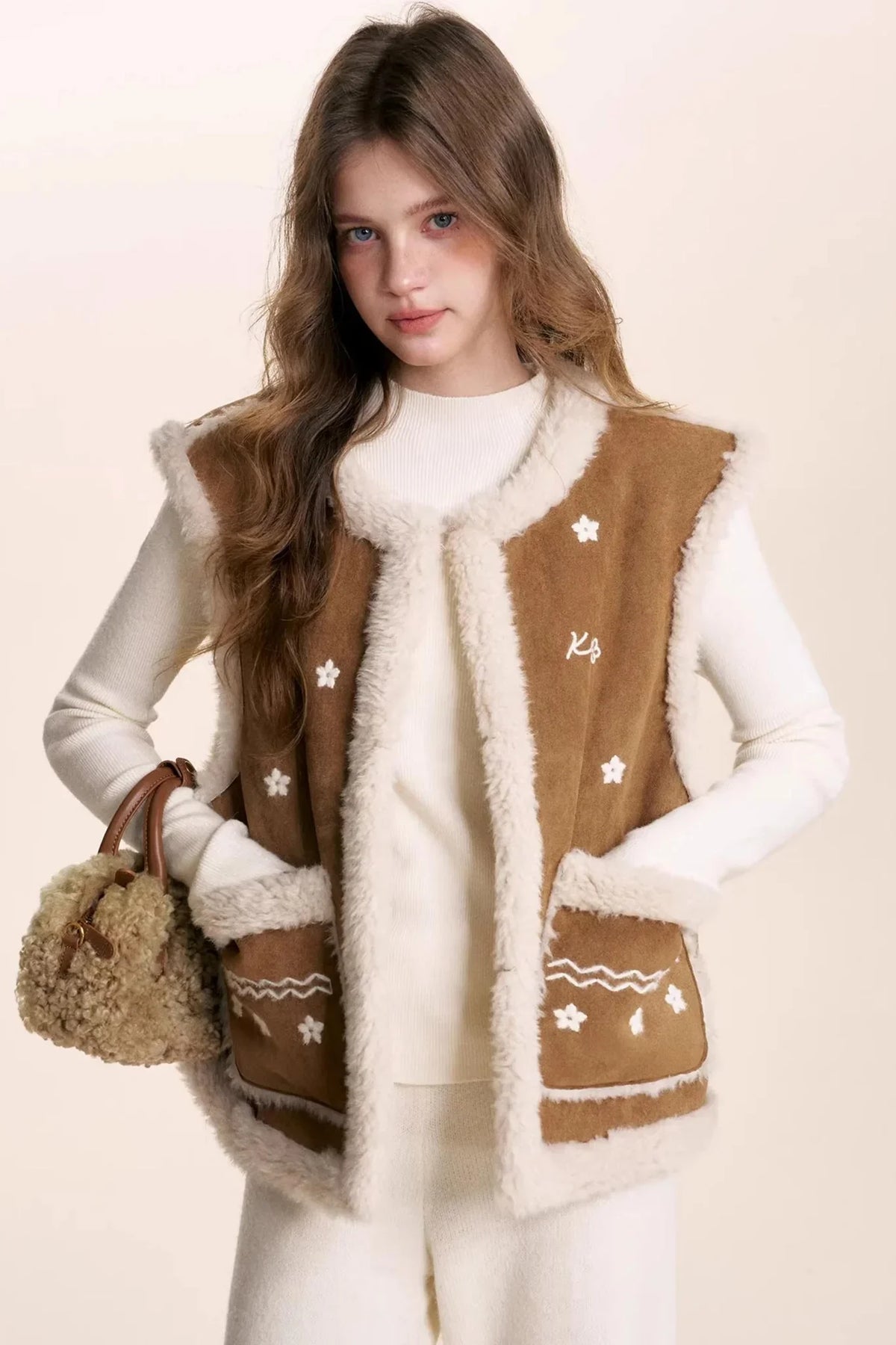 Cappuccino shearling lamb wool vest with floral embroidery.