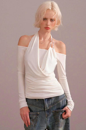 A woman wearing a white halter-neck off-the-shoulder top.