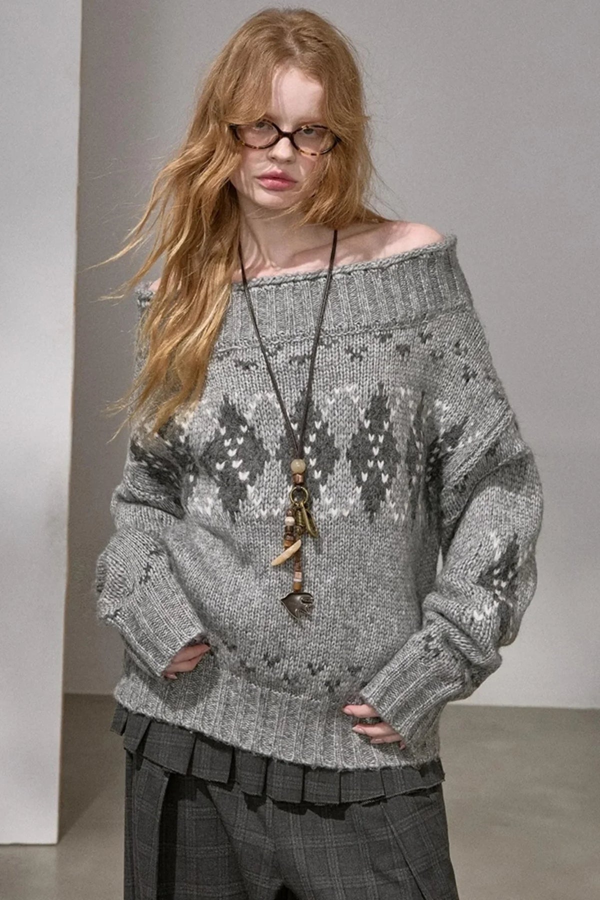 A thick knit argyle sweater with an off-shoulder neckline, available in gray and red.