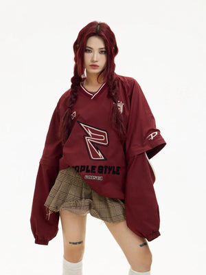 A red long-sleeve V-neck top with sporty graphic details.