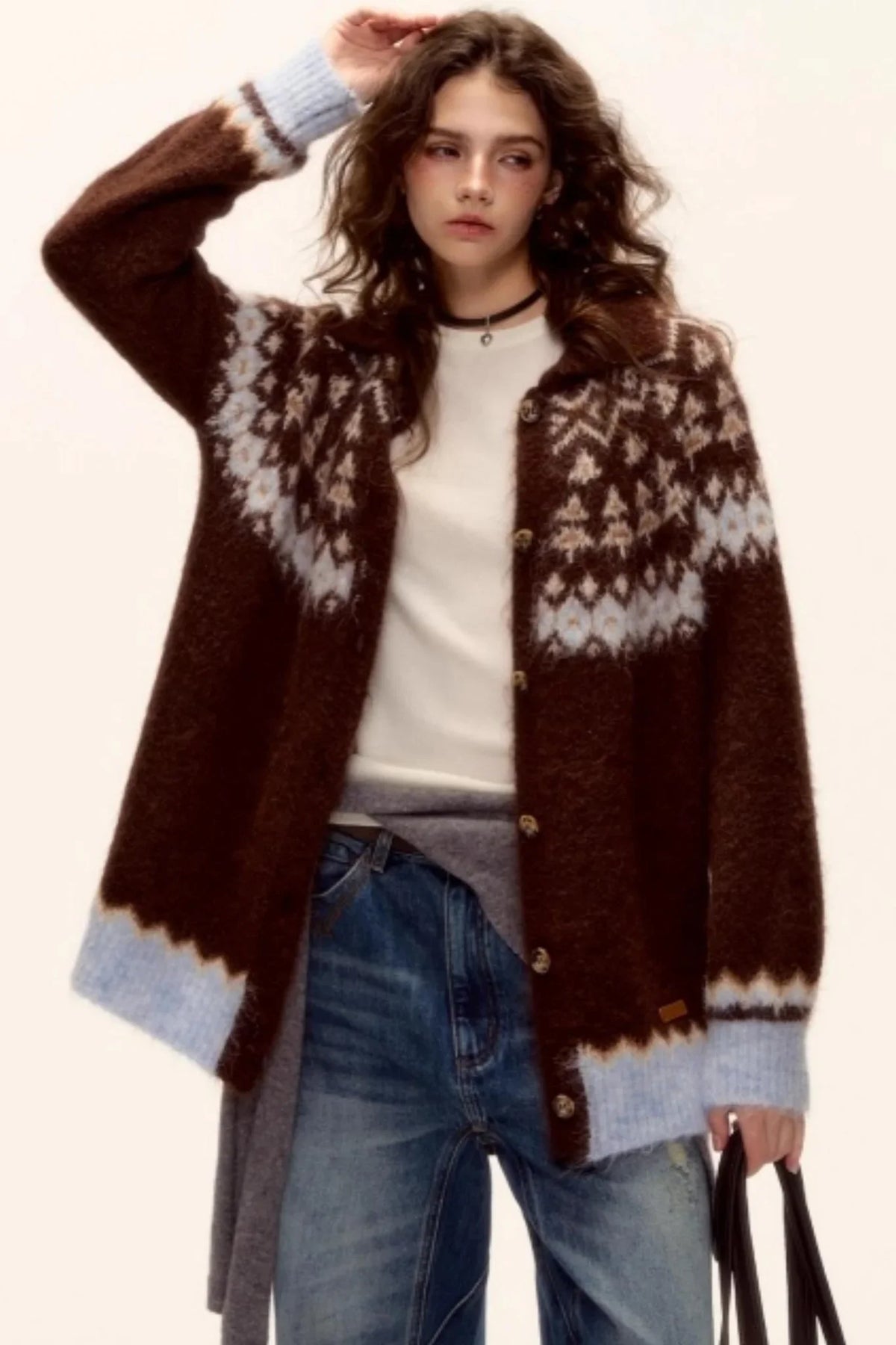 A model wearing a brown Fair Isle wool cardigan.
